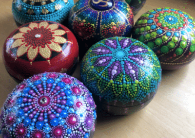 Brightly painted 4" teak boxes with mandala designs.