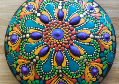 Hand cast art stone with brightly painted mandala design.