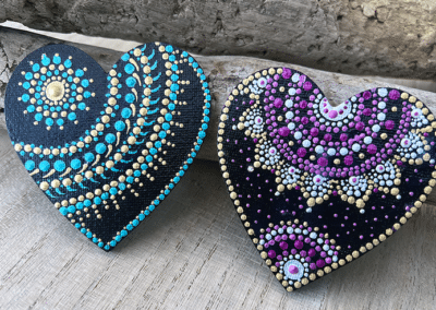 Heart-shaped magnets with bright mandala designs.