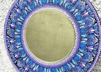 Eight inch mirror with mandala designs in blues and violets. Board is 16".