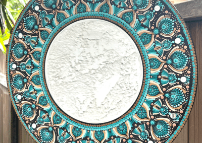 Wall mirror with mandala design, painted on 16″ wood board.
