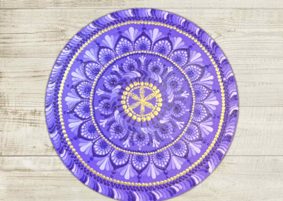 Shades of violet and gold paints on this 8" mandala.