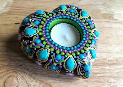 Hand-cast tea light holder in heart shape.