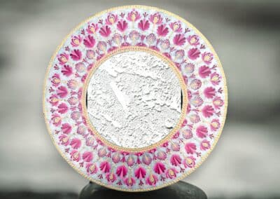 Eight inch mirror with mandala design in pinks and gold.