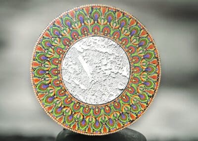 Eight inch mirror with mandala design in orange, green, purple, gold.
