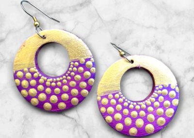 Lightweight, wooden earrings with acrylic paint and resin finish.