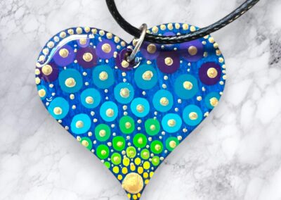 Lightweight, wooden heart pendant, acrylic paint and resin finish with a faux leather cord.